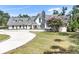 Stunning single Gathering home with a circular driveway, beautiful landscaping, and a stone chimney at 3114 Little Rd, Valrico, FL 33596