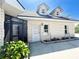 The home features a white door, white brick, and colorful landscaping at 3114 Little Rd, Valrico, FL 33596