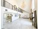 Bright foyer features a high ceiling, chandelier, marble floors, and ornate iron railing at 3114 Little Rd, Valrico, FL 33596