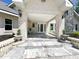 Front porch with marble floors, white brick columns, and two beautiful wall-mount lamps at 3114 Little Rd, Valrico, FL 33596