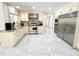 Bright kitchen features stainless steel appliances, custom cabinets, and marble floors at 3114 Little Rd, Valrico, FL 33596