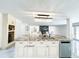 Open concept kitchen with large island, wine rack, and elegant lighting at 3114 Little Rd, Valrico, FL 33596