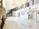 Grand marble entry featuring a wrought iron staircase, chandelier, and fireplace at 3114 Little Rd, Valrico, FL 33596