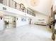 Bright living room boasts soaring ceilings, marble floors, and a stunning chandelier at 3114 Little Rd, Valrico, FL 33596