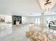 Bright and airy living space featuring marble flooring, fireplace, and elegant chandelier at 3114 Little Rd, Valrico, FL 33596