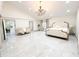 Spacious main bedroom features a chandelier and marble flooring at 3114 Little Rd, Valrico, FL 33596