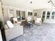 Covered outdoor seating area with brick columns, brick patio, and neutral wicker seating around a coffee table at 3114 Little Rd, Valrico, FL 33596