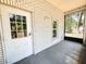 White brick home patio, including a door with window, adjacent to a screened in room at 3114 Little Rd, Valrico, FL 33596