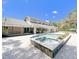 A beautiful in-ground pool with brick pavers surrounds this home's exterior at 3114 Little Rd, Valrico, FL 33596