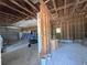 Unfinished room with exposed ceiling and walls, windows, debris, and wheelbarrow at 3114 Little Rd, Valrico, FL 33596