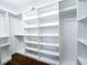 Spacious walk-in closet with custom shelving and ample storage, perfect for organizing your wardrobe at 3114 Little Rd, Valrico, FL 33596