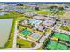 Aerial view of the community showcasing the pool, tennis courts, and recreational facilities at 31637 Cannon Rush Dr, San Antonio, FL 33576