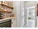 Stylish bar area adjacent to hall includes a wine fridge, wine rack, and decorative wallpaper at 31637 Cannon Rush Dr, San Antonio, FL 33576
