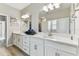 Stylish bathroom features dual sinks, quartz countertops, a walk in shower and ample storage space at 31637 Cannon Rush Dr, San Antonio, FL 33576