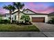 Charming single-Gathering home with a two-car garage, manicured landscaping, and a brick driveway at 31637 Cannon Rush Dr, San Antonio, FL 33576