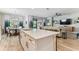 Spacious kitchen and living room with a large island, ample counter space, and stylish decor at 31637 Cannon Rush Dr, San Antonio, FL 33576