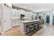 Modern kitchen with stainless appliances, white cabinets, large center island with seating, and open concept living at 31637 Cannon Rush Dr, San Antonio, FL 33576
