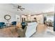 Bright and airy living area with plush seating, a ceiling fan, and seamless flow to kitchen and dining at 31637 Cannon Rush Dr, San Antonio, FL 33576