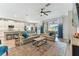 Open-concept living room with modern decor, plush seating, and sliding glass doors to the outdoor space at 31637 Cannon Rush Dr, San Antonio, FL 33576