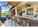 Spacious lanai with an outdoor kitchen, bar seating, comfortable seating, and ceiling fans at 31637 Cannon Rush Dr, San Antonio, FL 33576