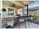 Covered outdoor bar with bar stool seating, built-in grill, and a ceiling fan in the screened lanai at 31637 Cannon Rush Dr, San Antonio, FL 33576