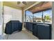Lanai with a grill, outdoor dining, beverage refrigerators, and a retractable shade at 31637 Cannon Rush Dr, San Antonio, FL 33576