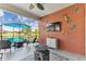 Inviting screened patio with colorful decor, comfortable seating, a ceiling fan, and a beautiful outdoor view at 31637 Cannon Rush Dr, San Antonio, FL 33576