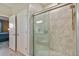 Modern glass enclosed shower with neutral tilework and a convenient, attached hand shower at 31637 Cannon Rush Dr, San Antonio, FL 33576