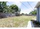 Fenced back yard featuring trees, grass, and walkway at 3253 57Th N Ave, St Petersburg, FL 33714