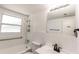Bright bathroom featuring a tub with shower, safety bars, modern fixtures, and tiled walls at 3253 57Th N Ave, St Petersburg, FL 33714