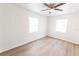 This bright bedroom features wood floors, two windows and ceiling fan at 3253 57Th N Ave, St Petersburg, FL 33714