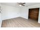 Bedroom features wood floors, fan and a closet with wood paneling at 3253 57Th N Ave, St Petersburg, FL 33714
