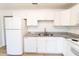 Kitchen with granite countertops, white cabinets, and stainless steel appliances at 3253 57Th N Ave, St Petersburg, FL 33714