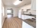 Bright kitchen with granite countertops, white cabinets, stainless appliances, and hardwood flooring at 3253 57Th N Ave, St Petersburg, FL 33714