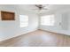 Bright living room features new floors, a ceiling fan, two windows, and white paint at 3253 57Th N Ave, St Petersburg, FL 33714