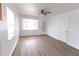 Bright living room features new floors, a ceiling fan, two windows, and white paint at 3253 57Th N Ave, St Petersburg, FL 33714