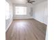Bright living room features two windows, new floors, a ceiling fan, and access to exterior at 3253 57Th N Ave, St Petersburg, FL 33714