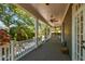 Inviting covered back porch with brick flooring, ceiling fans, and a view of the lush backyard at 3311 Home Ct, Tampa, FL 33611
