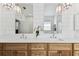 Bright bathroom with a double sink vanity, modern mirrors, and stylish light fixtures at 3311 Home Ct, Tampa, FL 33611