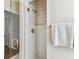 Bathroom shower with glass door, tiled walls, and gold fixtures at 3311 Home Ct, Tampa, FL 33611