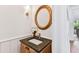 Charming powder room with granite countertop, gold accents, a decorative mirror, and an orchid at 3311 Home Ct, Tampa, FL 33611