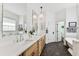 Elegant bathroom featuring a double vanity, soaking tub, and hexagon tile floors at 3311 Home Ct, Tampa, FL 33611
