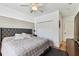 Comfortable bedroom with a ceiling fan, closet, and a stylish upholstered headboard and accent wall at 3311 Home Ct, Tampa, FL 33611