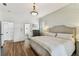 Tranquil bedroom featuring a shiplap wall, wood floors and neutral decor at 3311 Home Ct, Tampa, FL 33611