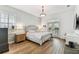 Cozy bedroom with wood floors, shiplap accent wall, and french doors to the outside at 3311 Home Ct, Tampa, FL 33611
