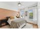 Bright bedroom with accent wall, two windows, ceiling fan, and closet at 3311 Home Ct, Tampa, FL 33611