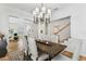 Elegant dining room with modern chandelier, stylish chairs, and view to an office space with wainscoting at 3311 Home Ct, Tampa, FL 33611