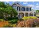 Charming two-story home with lush landscaping and a welcoming front porch with white columns at 3311 Home Ct, Tampa, FL 33611