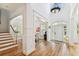 Elegant foyer with hardwood floors, staircase, and views into the dining and living spaces at 3311 Home Ct, Tampa, FL 33611