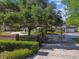 Gated entrance to a stately home with mature landscaping and a circular driveway at 3311 Home Ct, Tampa, FL 33611